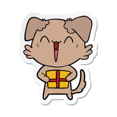 sticker of a happy little cartoon dog with present