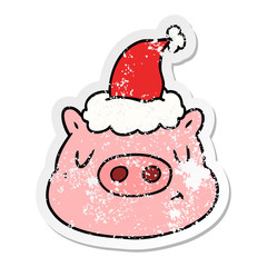 distressed sticker cartoon of a pig face wearing santa hat