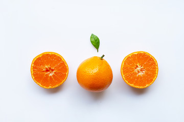 Orange fruits and green leaf on a white background.