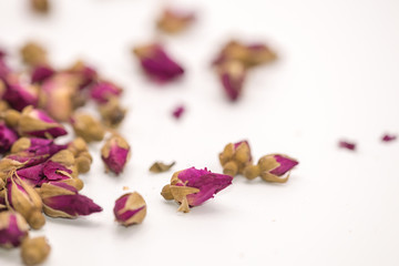 Dried rose petal flower on isolate white background.Blurred close up flower buds and tea on white background.
