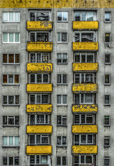 Fototapeta premium Former soviet (Polish) apartment block with yellow balconies