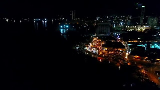 Night Aerial View of a Chinese Template next to the sea in the city of Kota Kinabalu - Malaysia - Aerial - Backward Dolly 