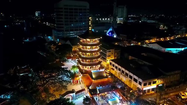 Night Aerial View of a Chinese Template next to the sea in the city of Kota Kinabalu - Malaysia - Aerial -  Dolly Forward 