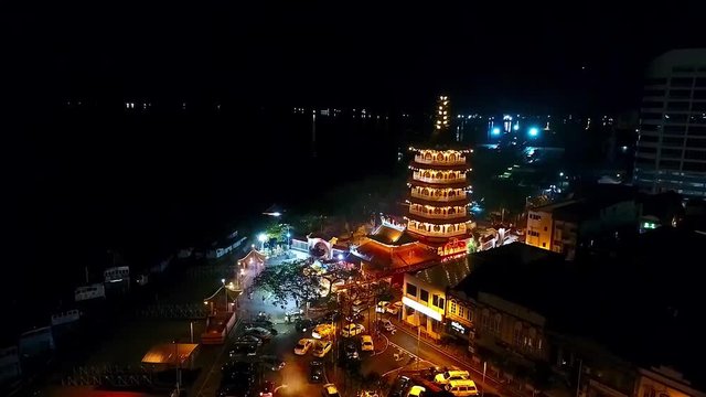 Night Aerial View of a Chinese Template next to the sea in the city of Kota Kinabalu - Malaysia - Aerial - Crane Up 