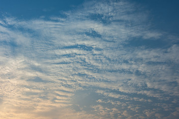 Naklejka na ściany i meble Blue sky with white clouds, the sun rises.