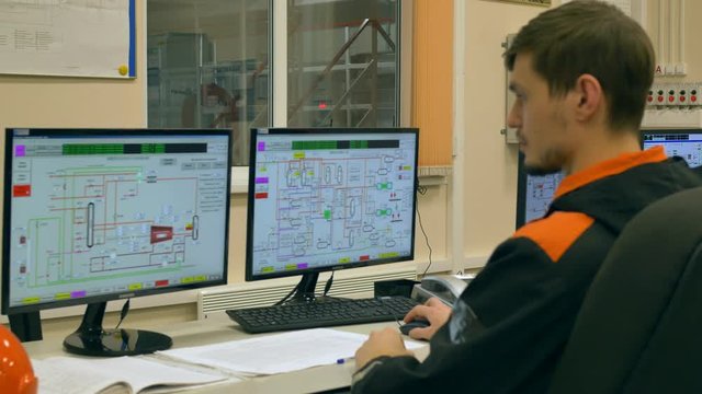 Engineer/ Technician Working on a Personal Computer dashboard in the control room