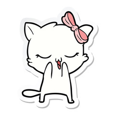 sticker of a cartoon cat with bow on head