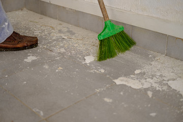 Man sweeping the floor after his job.