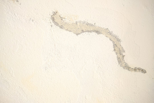 work to repair a white wall.