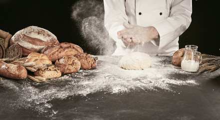 Baker clapping his hands in a cloud of flour