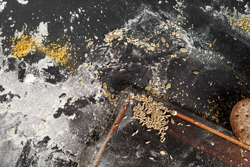 Messy bakery counter with assorted seeds and flour