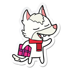 sticker of a cartoon wolf with christmas present laughing