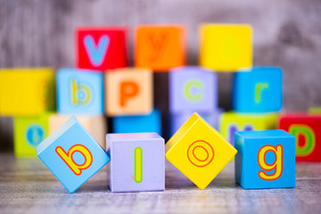 Colorful wooden alphabet, blog write. Education concept photo.