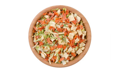 dried vegetables or soup vegetables in wooden bowl isolated on white background. Spices and food ingredients.