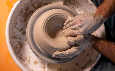 Professional potter making bowl in pottery workshop