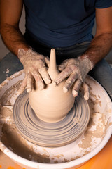 Professional potter making bowl in pottery workshop