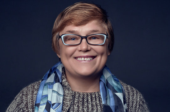 Portrait of a pensioner with glasses on a blue background