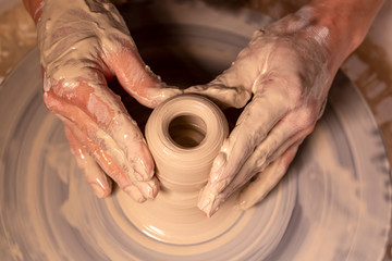 Professional potter making bowl in pottery workshop