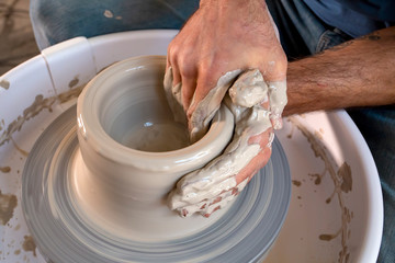 Professional potter making bowl in pottery workshop