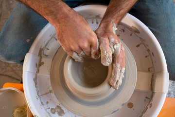 Professional potter making bowl in pottery workshop