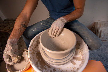 Professional potter making bowl in pottery workshop