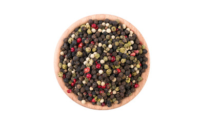 colored pepper peppercorns in wooden bowl isolated on white background. Spices and food ingredients.