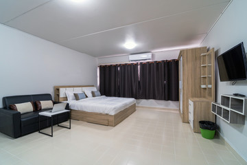 Luxury Interior bedroom with leather sofa of living room, Studio room type of condominium or apartment, service apartment and Accommodations Concept