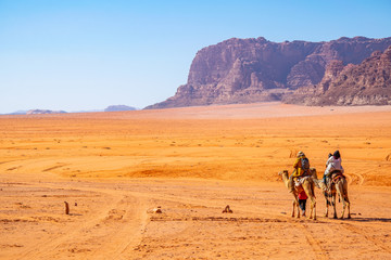 Tourists on camels crossing wadi rum desert in Jordan © dudlajzov