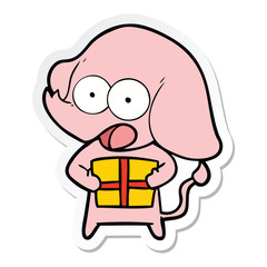 sticker of a cute cartoon elephant with christmas present