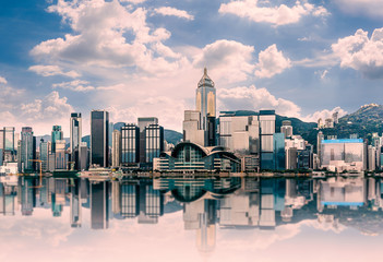 Hong Kong cityscape in the morning : View from Victoria Harbour with beautiful sunrise and reflection - obrazy, fototapety, plakaty