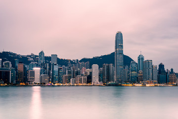 Hong Kong cityscape in the morning : View from Victoria Harbour with beautiful sunrise and reflection