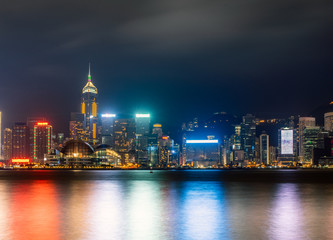 Fototapeta na wymiar Hong Kong harbour by night with long exposure mode. Night scene with neon lightings