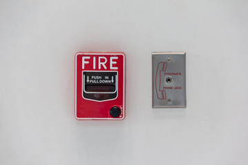 red fire alarm switch attach with white wall