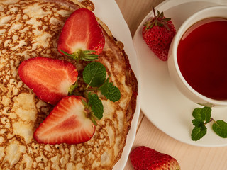 homemade pancakes with strawberry jam and fresh strawberries