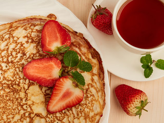 homemade pancakes with strawberry jam and fresh strawberries