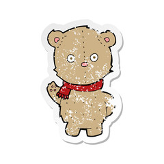 retro distressed sticker of a cartoon teddy bear wearing scarf