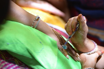 applying henna on hand, bride , traditional Hindu wedding , Rajasthan, India	