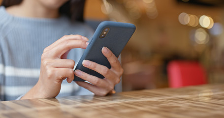 Woman use of mobile phone in restaurant