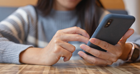 Woman use of cellphone in coffee shop