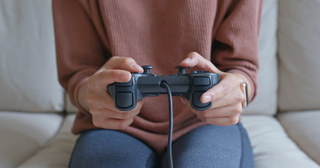 Woman play tv game at home