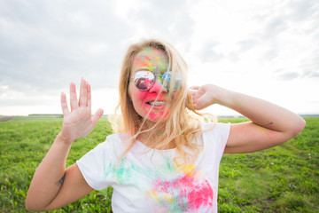Holi festival and people concept - Happy woman in color on nature