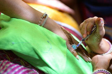applying henna on hand, bride , traditional Hindu wedding , Rajasthan, India	