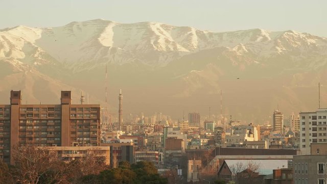 Establishing shot, showing Teheran, with huge mountains in the background.