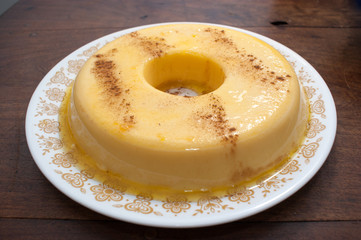 home made vanilla and cinnamon flan over a wooden table