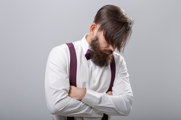 People, style and fashion concept - Portrait of bearded man dressed in white shirt over grey background