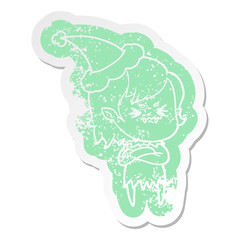 annoyed cartoon distressed sticker of a vampire girl wearing santa hat