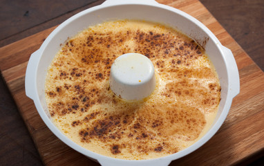 home made vanilla and cinnamon flan over a wooden table