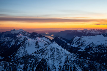 Aerial view of Canadian Mountain Landscape during a vibrant sunset. Taken North of Vancouver, British Columbia, Canada.