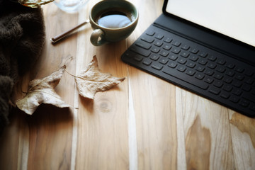 Coffee with tablet, smart keyboard on wood and copy space