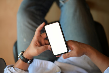 Top view man at office using mobile smartphone
